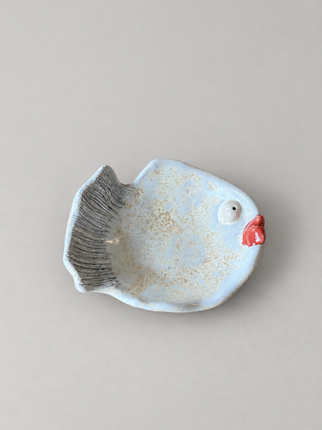 Pale blue ceramic fish dish with red lips